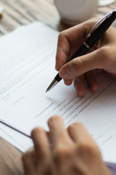 businessman-examining-papers-table