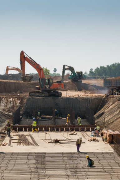 heavy-machines-construction-workers-working-building